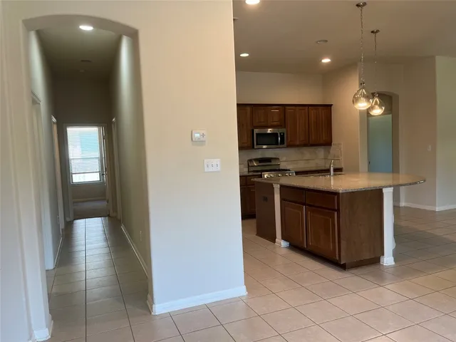 a kitchen with stainless steel appliances granite countertop a sink and a stove with a cabinets
