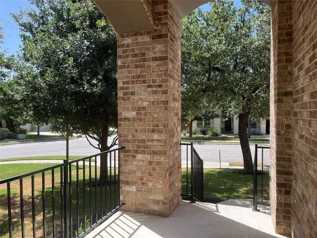 a view of a door of the house with a tree
