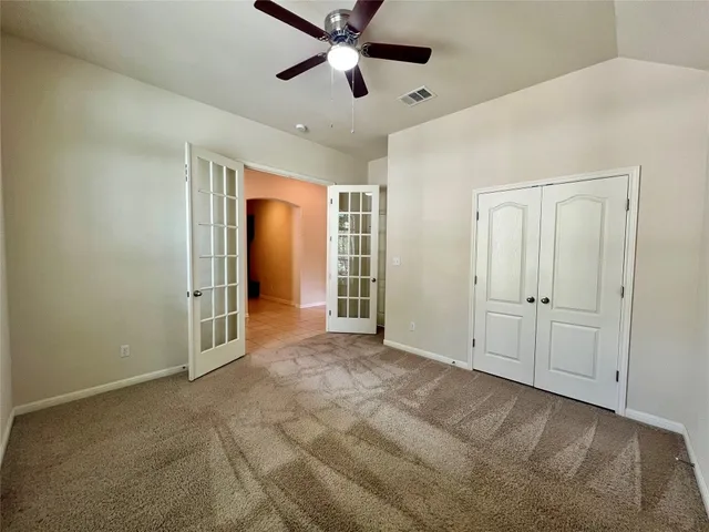 a view of empty room with ceiling fan