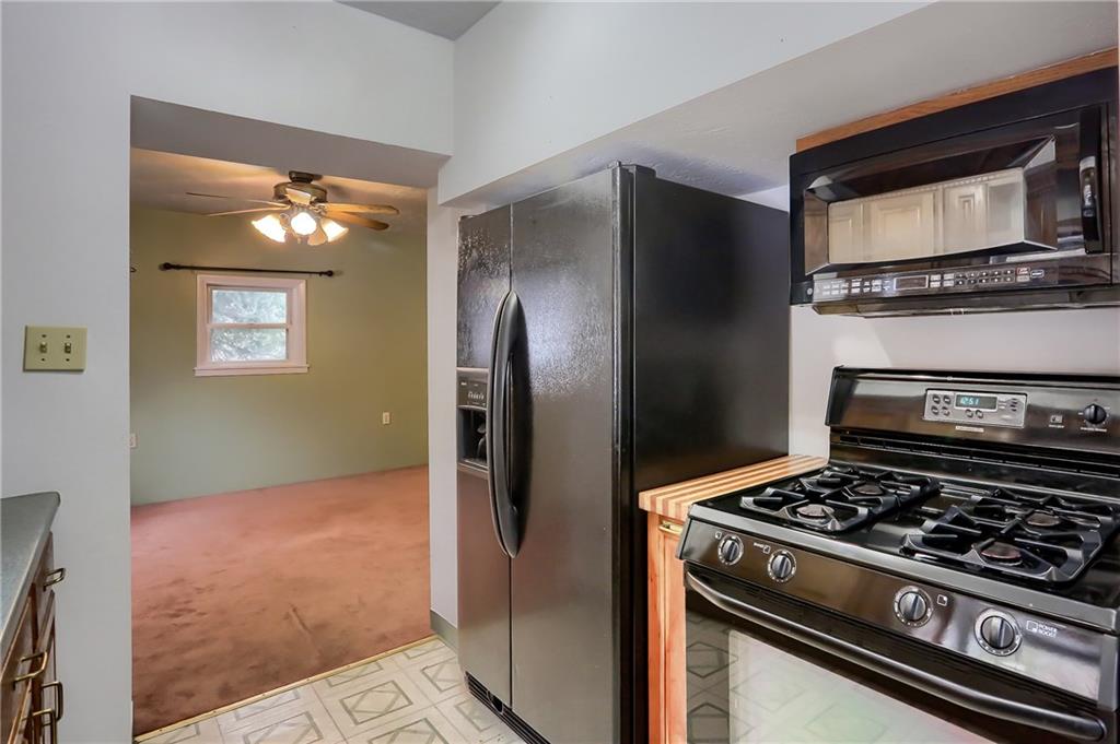 113 Wible Run Road Pittsburgh, PA 15209 - Photo 4 of 21 a kitchen with granite countertop a stove and a refrigerator