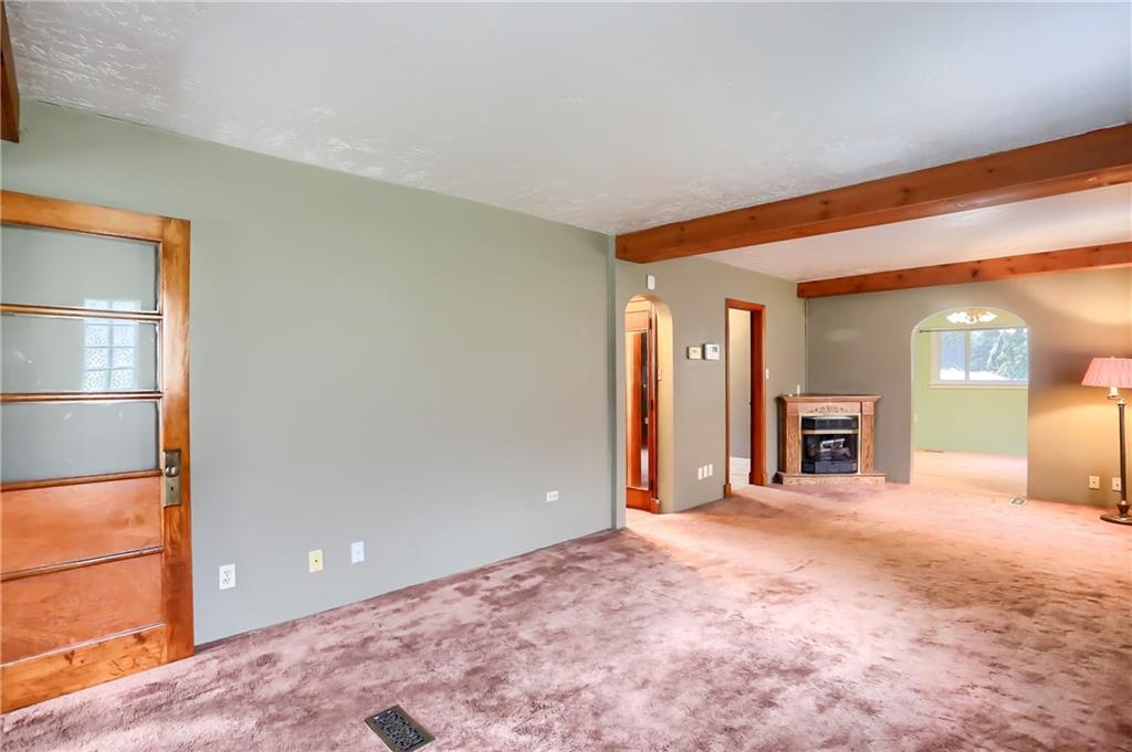 113 Wible Run Road Pittsburgh, PA 15209 - Photo 8 of 21 a view of a livingroom with a fireplace and window