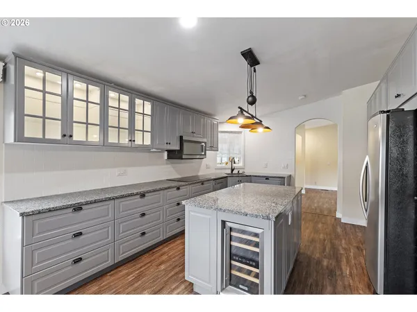 a kitchen with a stove a sink and a refrigerator