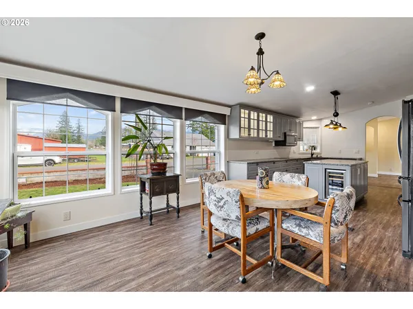 a view of a dining room with furniture a chandelier and wooden floor