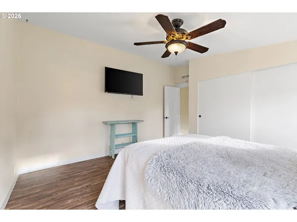 a view of a livingroom with a ceiling fan and wooden floor