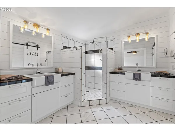 a large white kitchen with cabinets