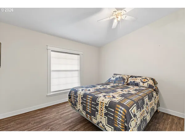 a bedroom with a bed and a chandelier fan