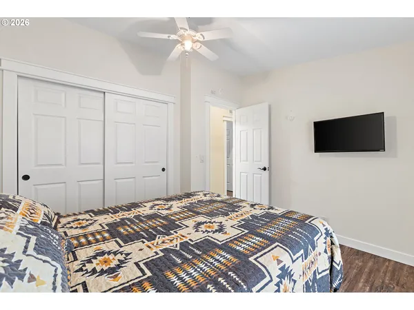 a bedroom with a bed and a flat screen tv