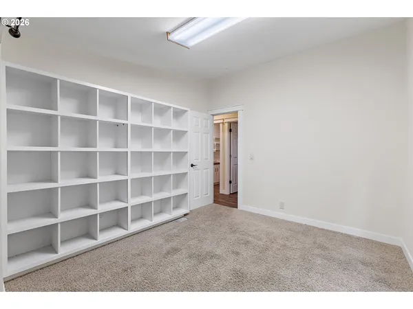 a view of an empty room with empty shelves