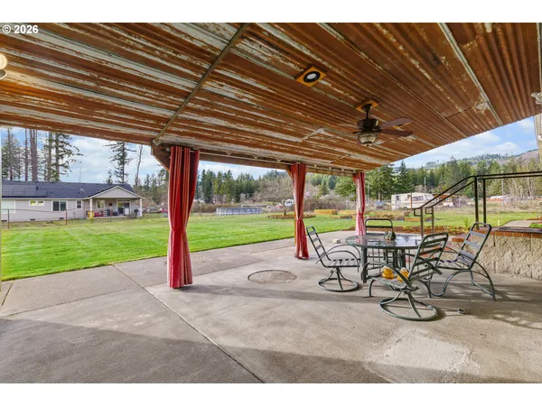 a view of a patio with a table and chairs