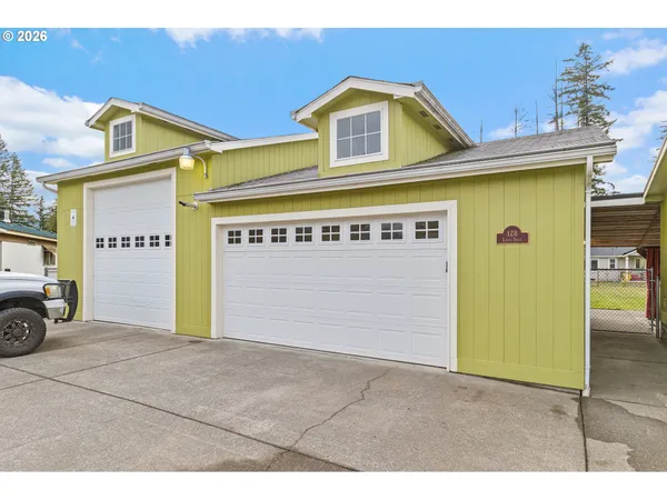 a front view of a building with parking area