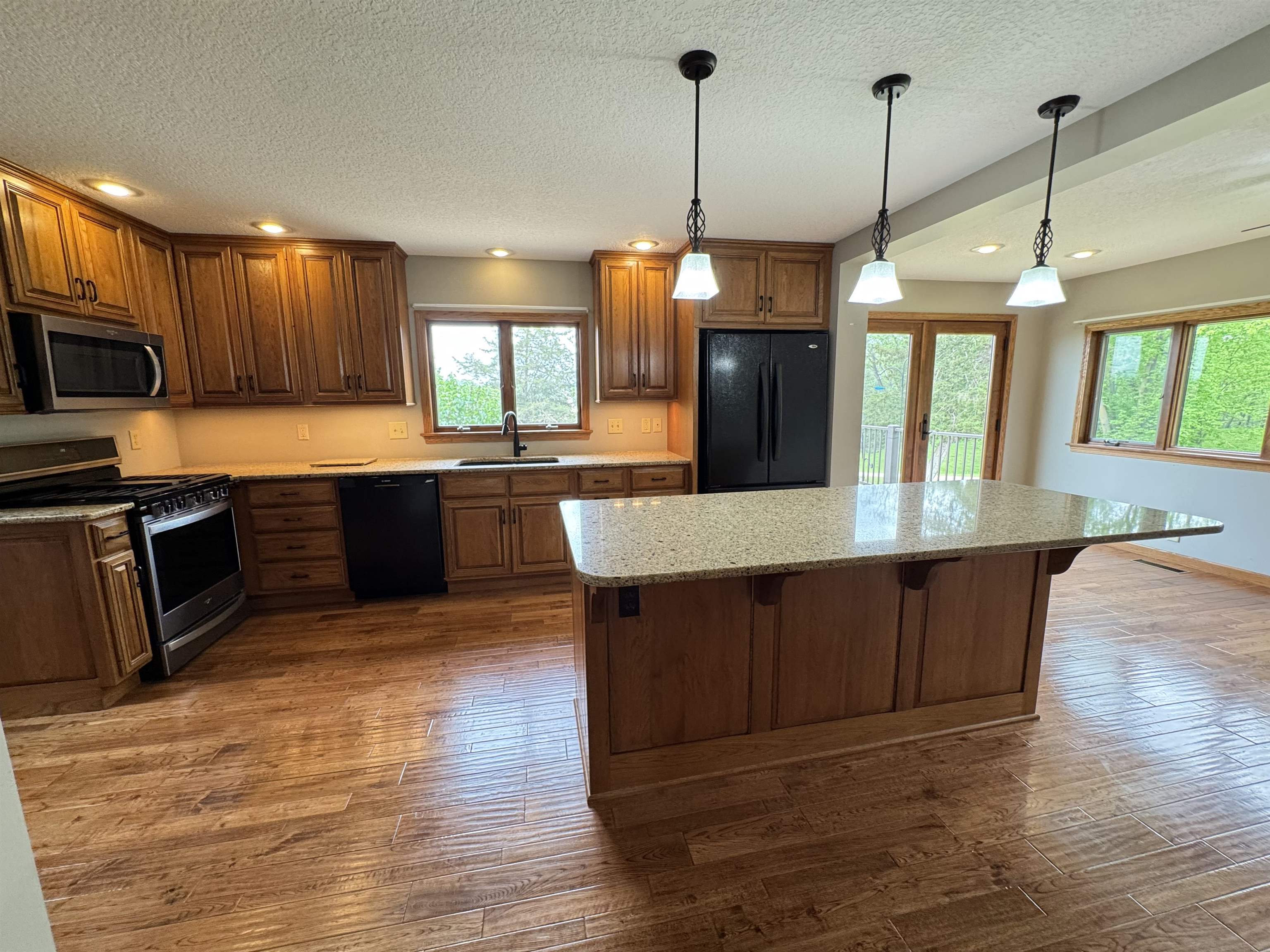 25303 Spring Valley Road Shannon, IL 61078 - Photo 11 of 22 a kitchen with stainless steel appliances granite countertop wooden floors and granite counter tops