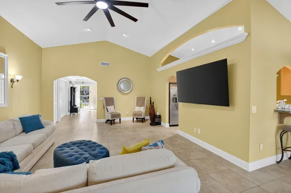 a bedroom with a bed a dresser and a flat screen tv