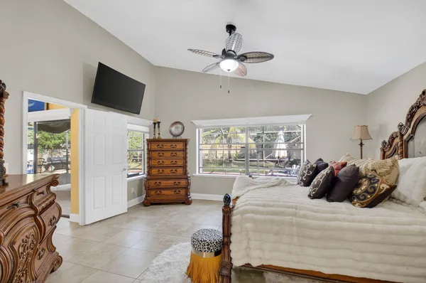 a bedroom with a large bed and a flat screen tv