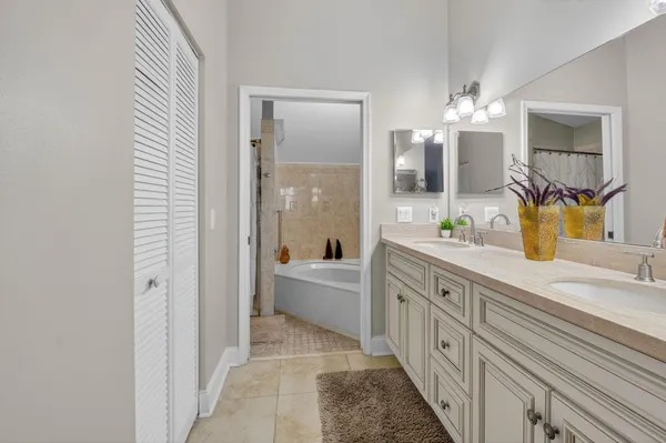 a spacious bathroom with a bathtub sink and mirror