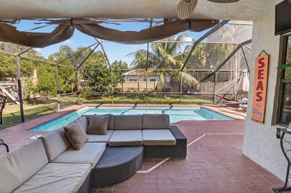 a view of a patio with table and chairs and potted plants
