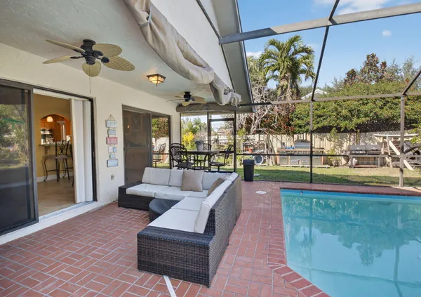 a front view of a house with garden and plants