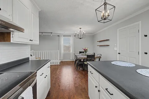 a kitchen with sink cabinets and wooden floor