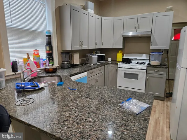 a view of a backyard with wooden fence