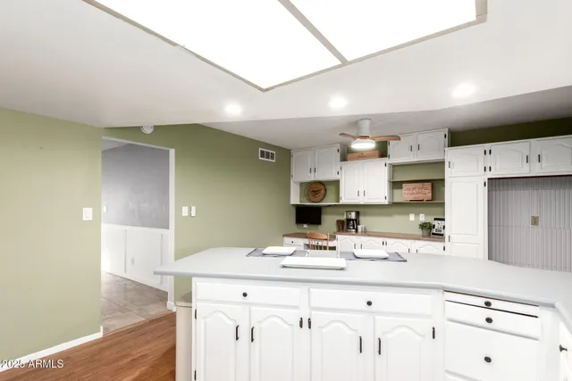 a kitchen with kitchen island a sink stainless steel appliances and cabinets