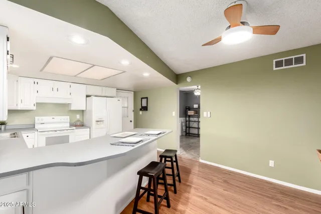 a kitchen with a table and chairs
