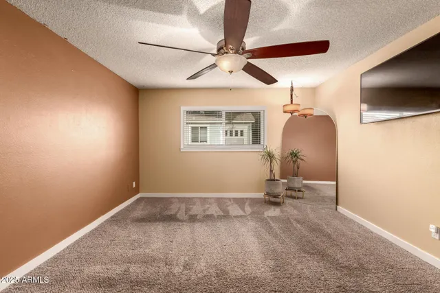 a view of room with a ceiling fan