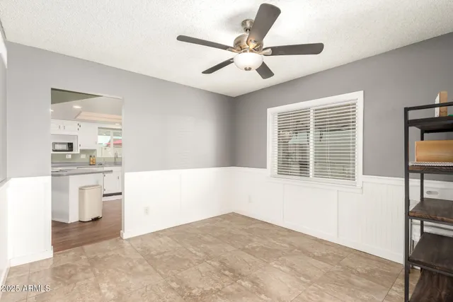 a view of kitchen with furniture and refrigerator