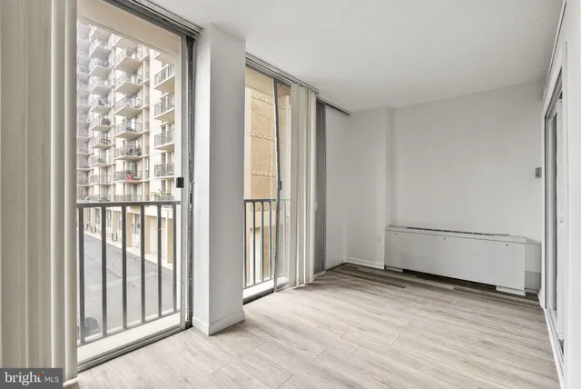 a view of a room with wooden floor and windows