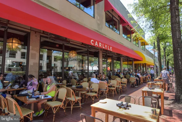 a view of people sitting in front of shop