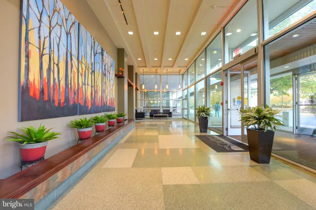 a lobby with furniture and floor to ceiling window