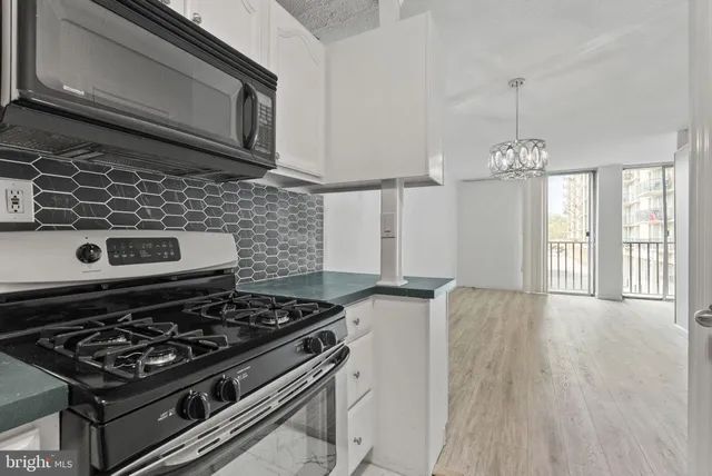 a kitchen with a stove and a microwave
