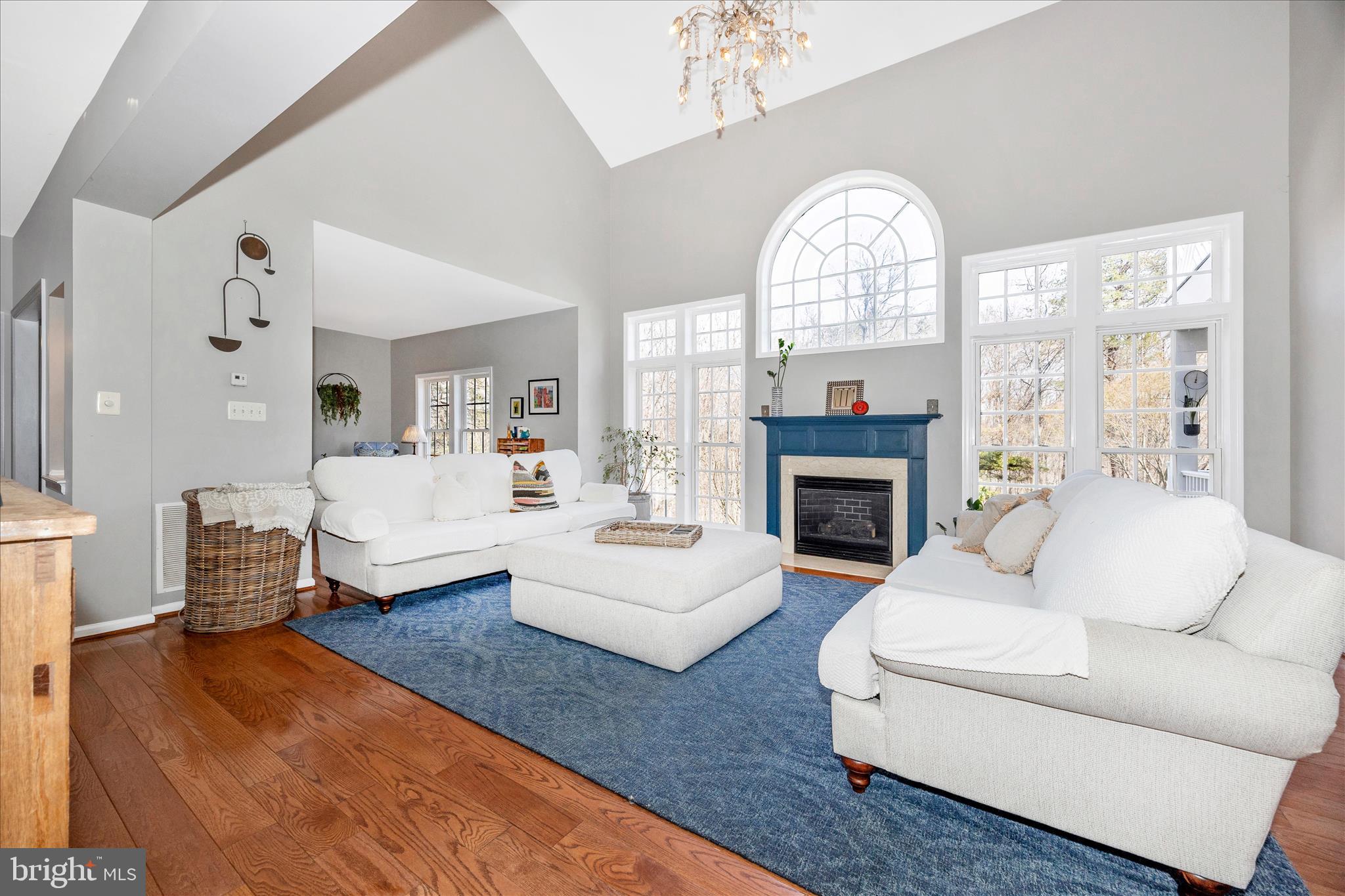 6243 Woodville Road Mount Airy, MD 21771 - Photo 11 of 50 a living room with furniture a fireplace and a large window