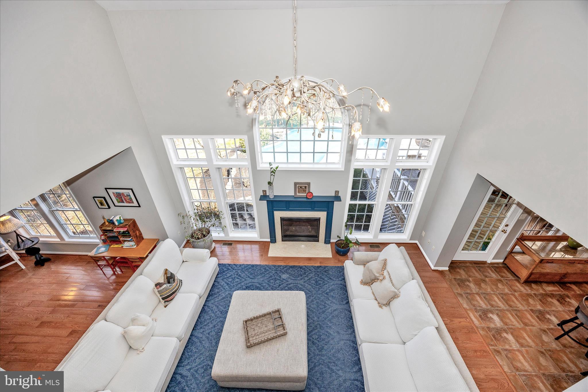 6243 Woodville Road Mount Airy, MD 21771 - Photo 19 of 50 a living room with furniture large window and a chandelier
