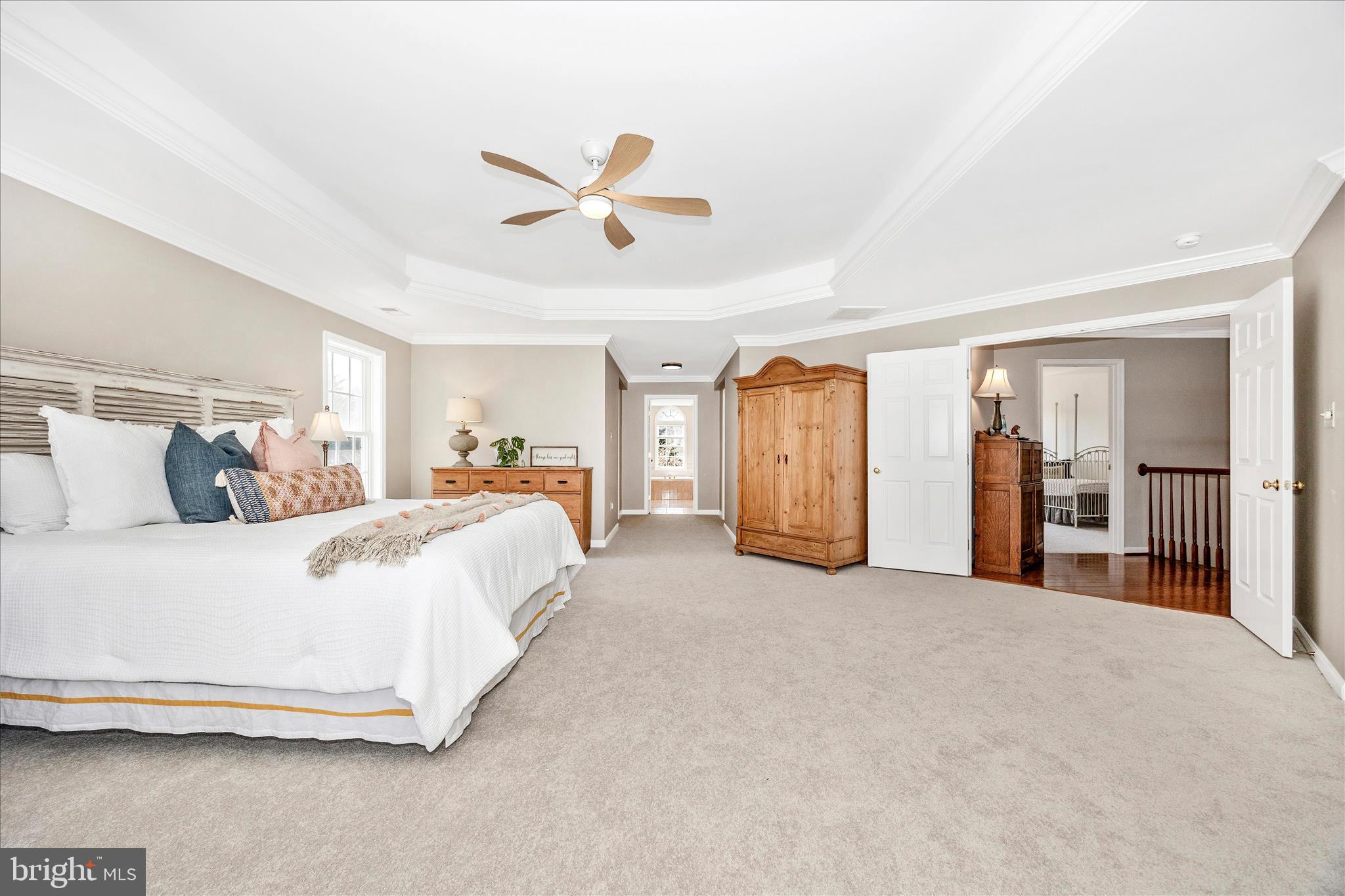 6243 Woodville Road Mount Airy, MD 21771 - Photo 21 of 50 a spacious bedroom with a bed and ceiling fan