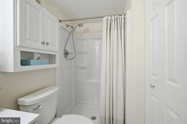 a bathroom with a shower a toilet and sink