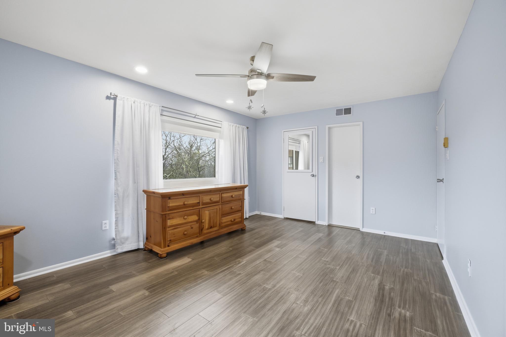 1680 Huntingdon Pike, Unit 238 Huntingdon Valley, PA 19006 - Photo 19 of 32 an empty room with wooden floor cabinet and windows