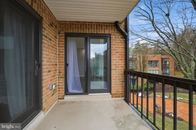 a view of a brick house with a large window