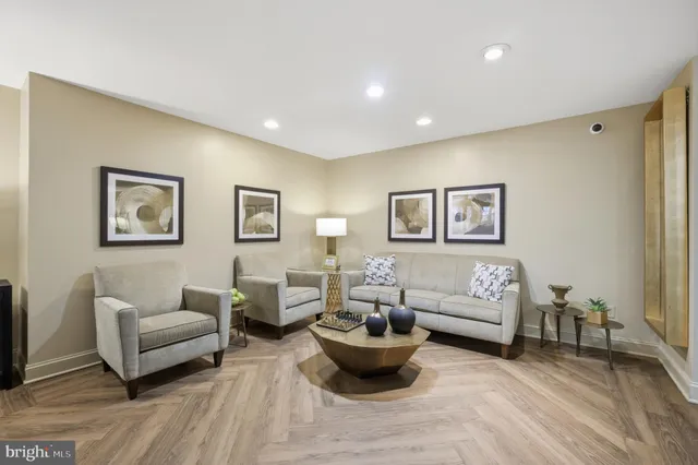 a living room with furniture and a wooden floor