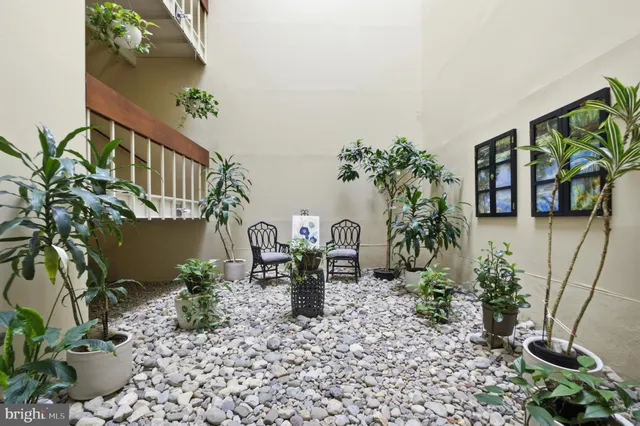 a view of balcony with furniture and potted plants