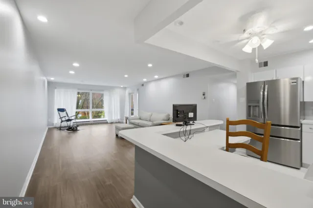 a kitchen with stainless steel appliances a refrigerator and a sink