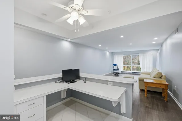 a living room with stainless steel appliances kitchen island granite countertop furniture and a view of living room