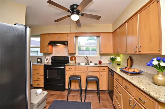 a kitchen with a stove a refrigerator and a sink