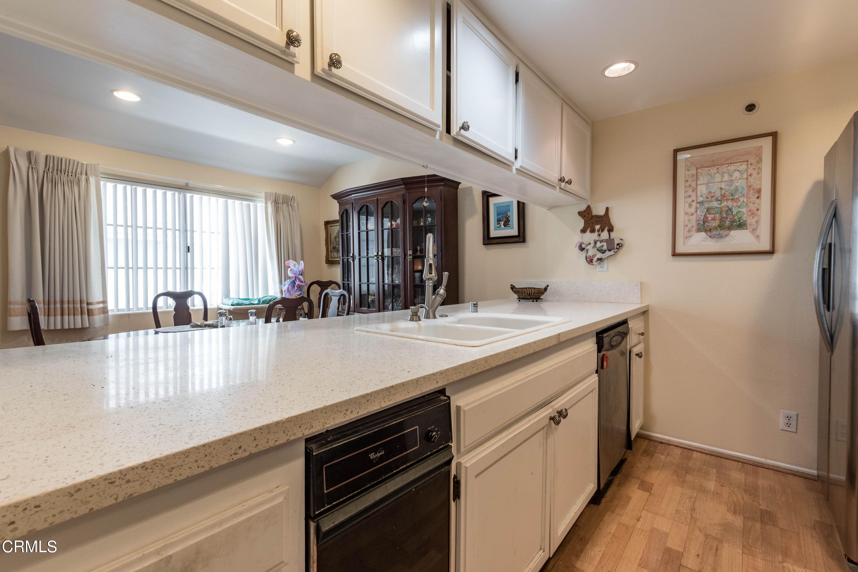 456 West Wooley Road Oxnard, CA 93030 - Photo 2 of 17 a kitchen with stainless steel appliances granite countertop a lot of counter space and wooden floors