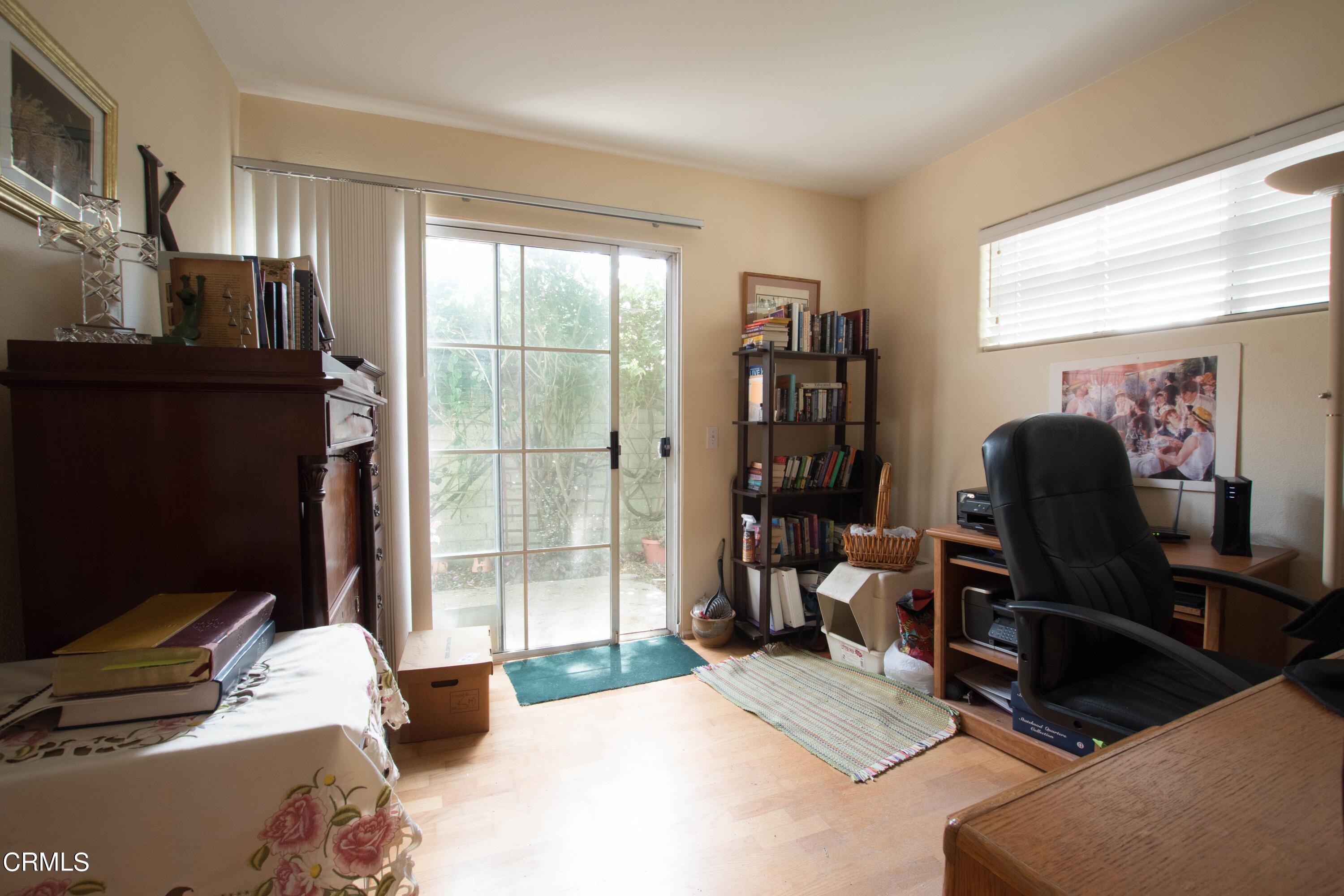 456 West Wooley Road Oxnard, CA 93030 - Photo 12 of 17 a bedroom with a bed and large windows