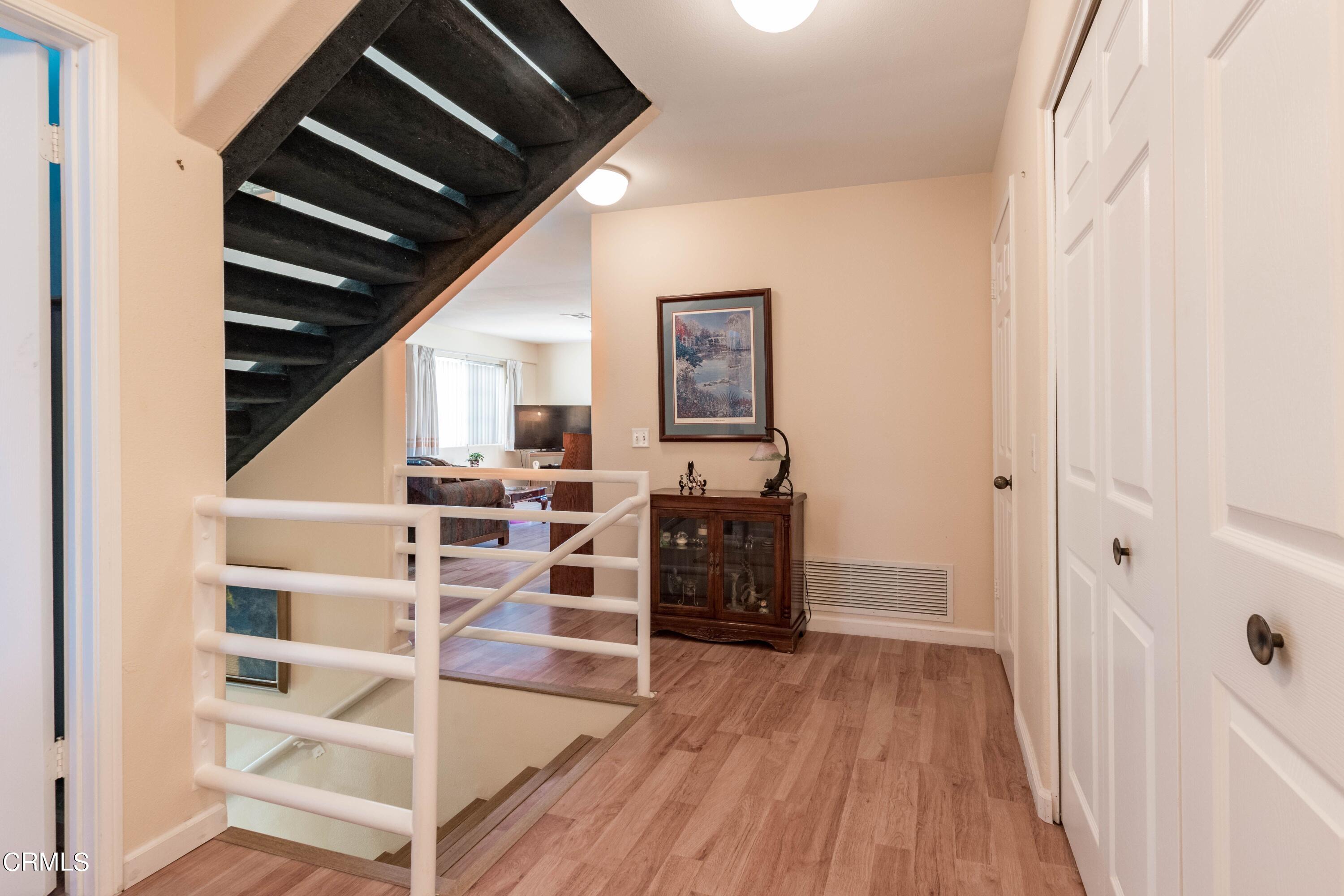 456 West Wooley Road Oxnard, CA 93030 - Photo 8 of 17 a view of a hallway with wooden floor and staircase