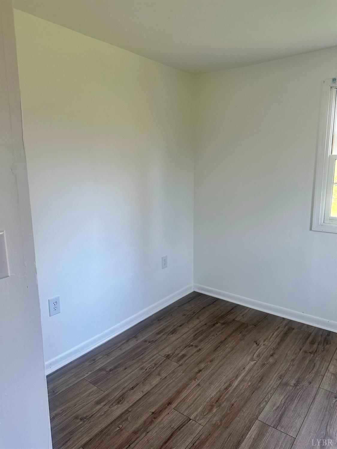 476 Kenmore Road Amherst, VA 24521 - Photo 12 of 32 a view of an empty room with wooden floor and a window