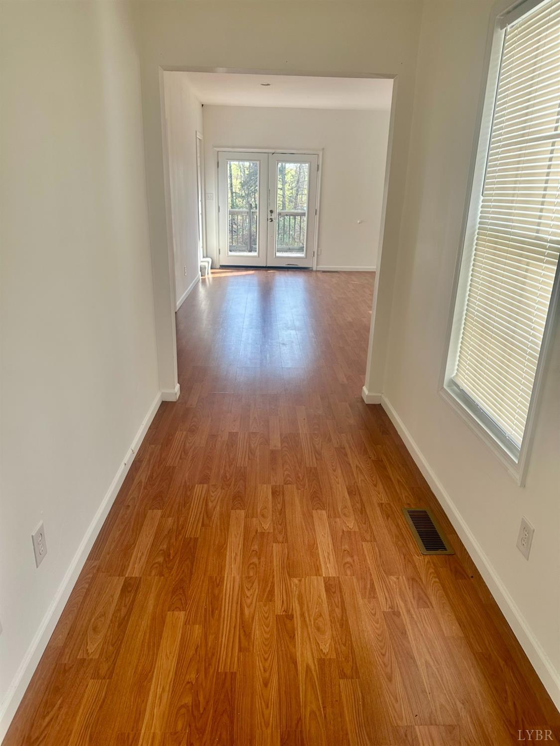 476 Kenmore Road Amherst, VA 24521 - Photo 17 of 32 an empty room with wooden floor and windows