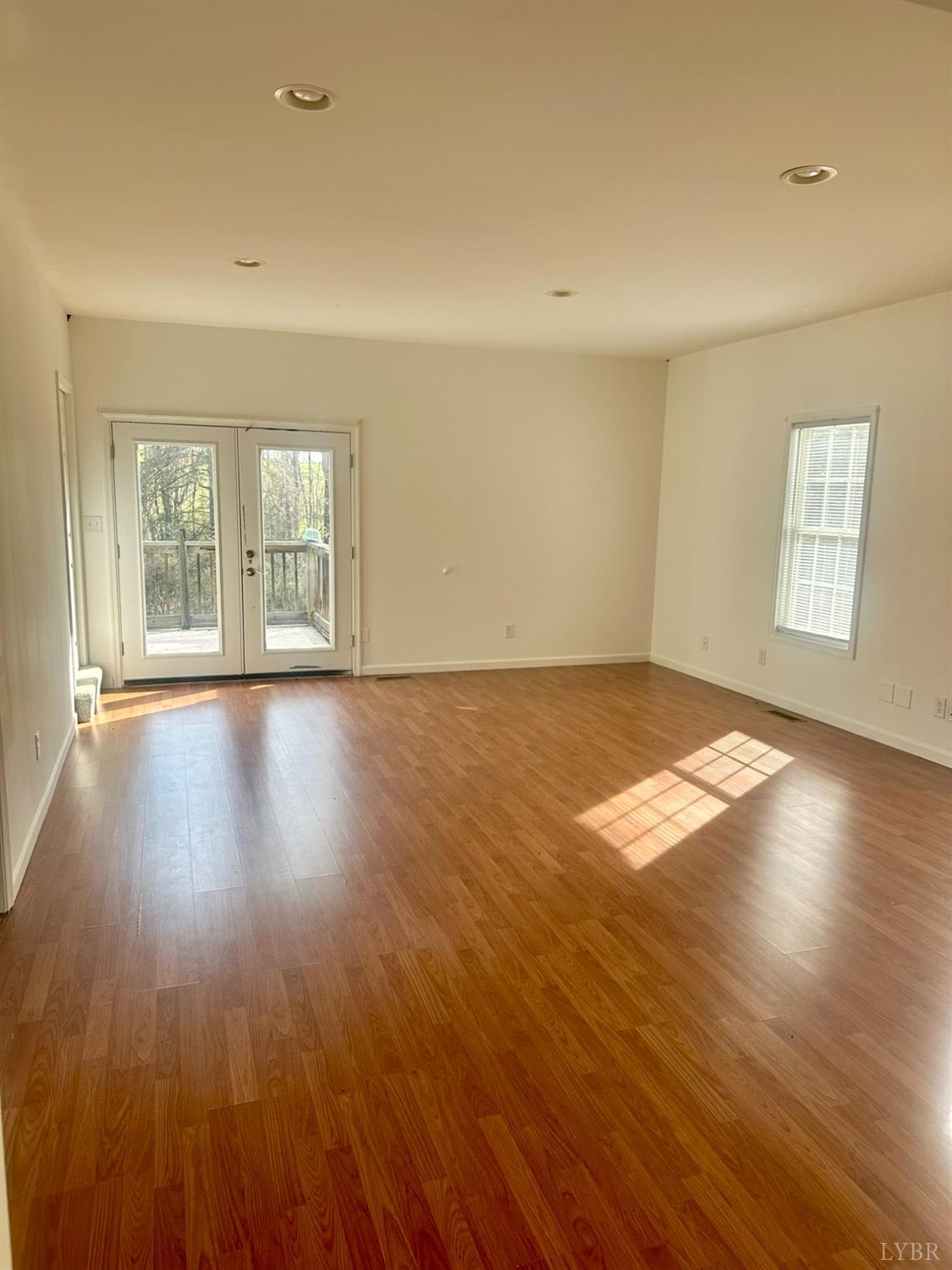 476 Kenmore Road Amherst, VA 24521 - Photo 18 of 32 an empty room with wooden floor and windows