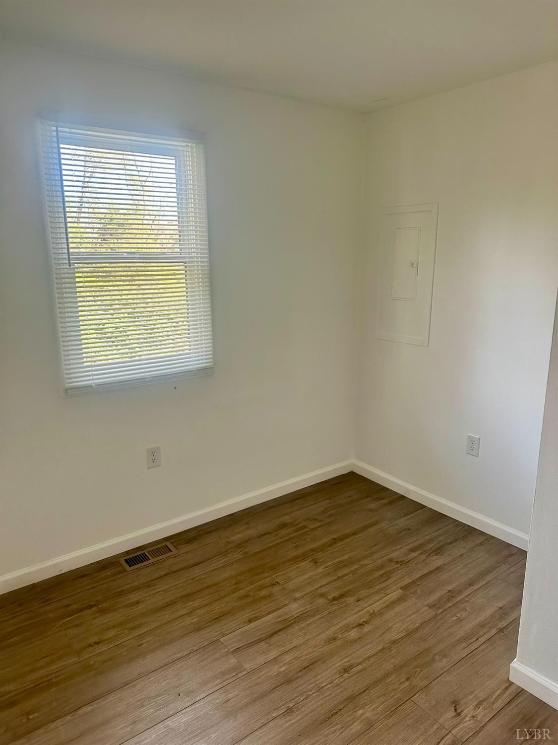476 Kenmore Road Amherst, VA 24521 - Photo 10 of 32 a view of an empty room with wooden floor and a window