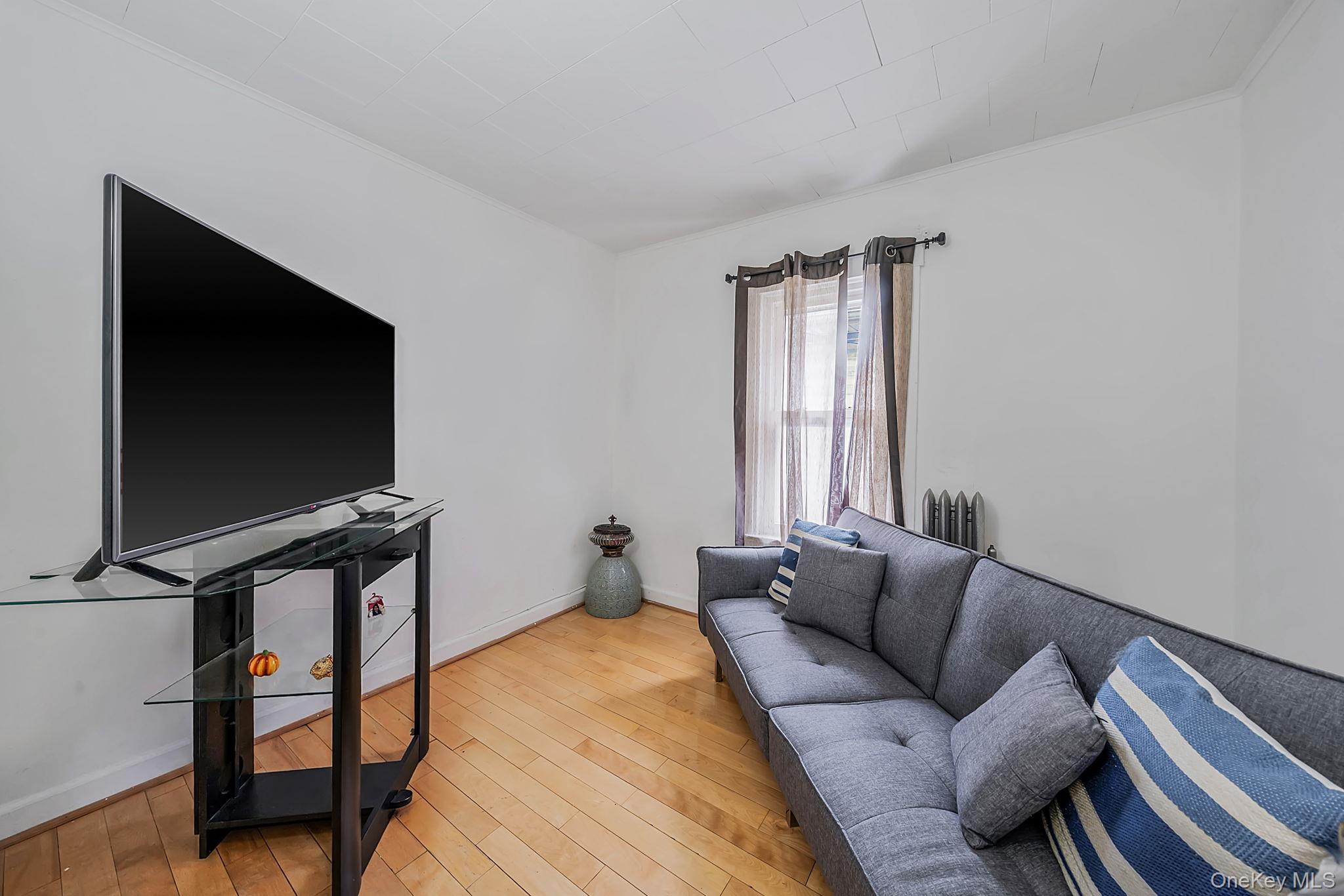 93-20 92nd Avenue Queens, NY 11421 - Photo 14 of 21 a living room with furniture and a flat screen tv