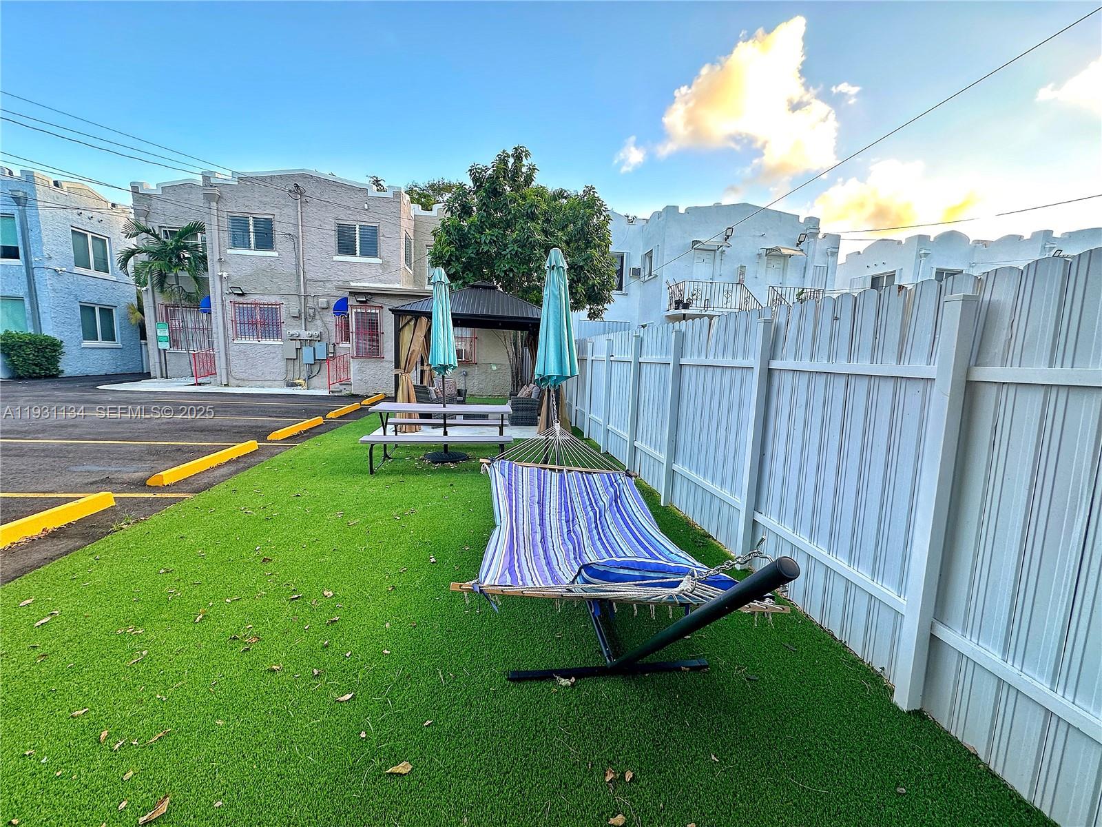 2153 Southwest 14th Terrace, Unit 1 Miami, FL 33145 - Photo 16 of 17 a view of a backyard with a sitting area and slide